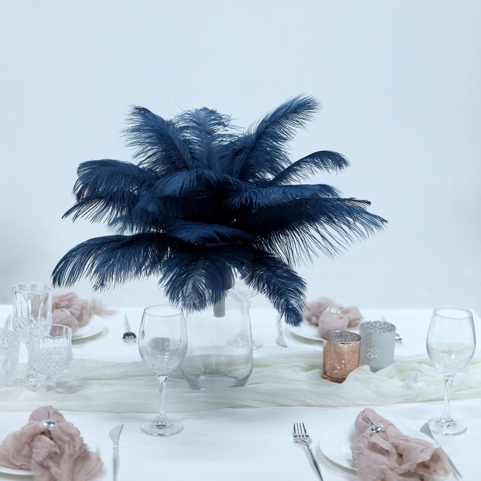 Navy blue real ostrich feathers in a decorative centerpiece arrangement.