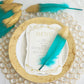 Metallic gold dipped turquoise feathers for party decoration.