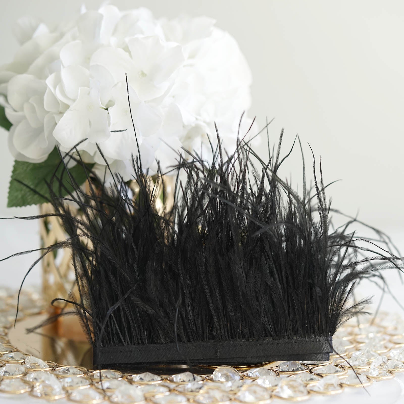 Black ostrich feather fringe trim with satin ribbon tape.