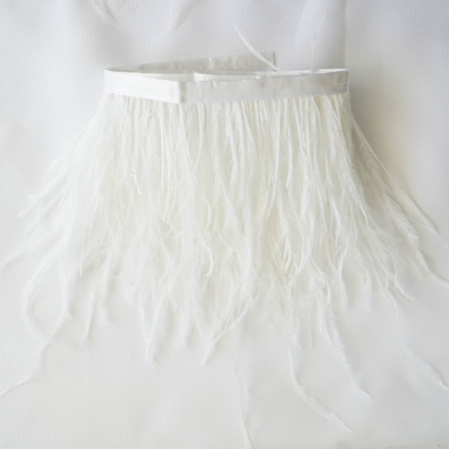 White real ostrich feather fringe trim with satin ribbon tape.