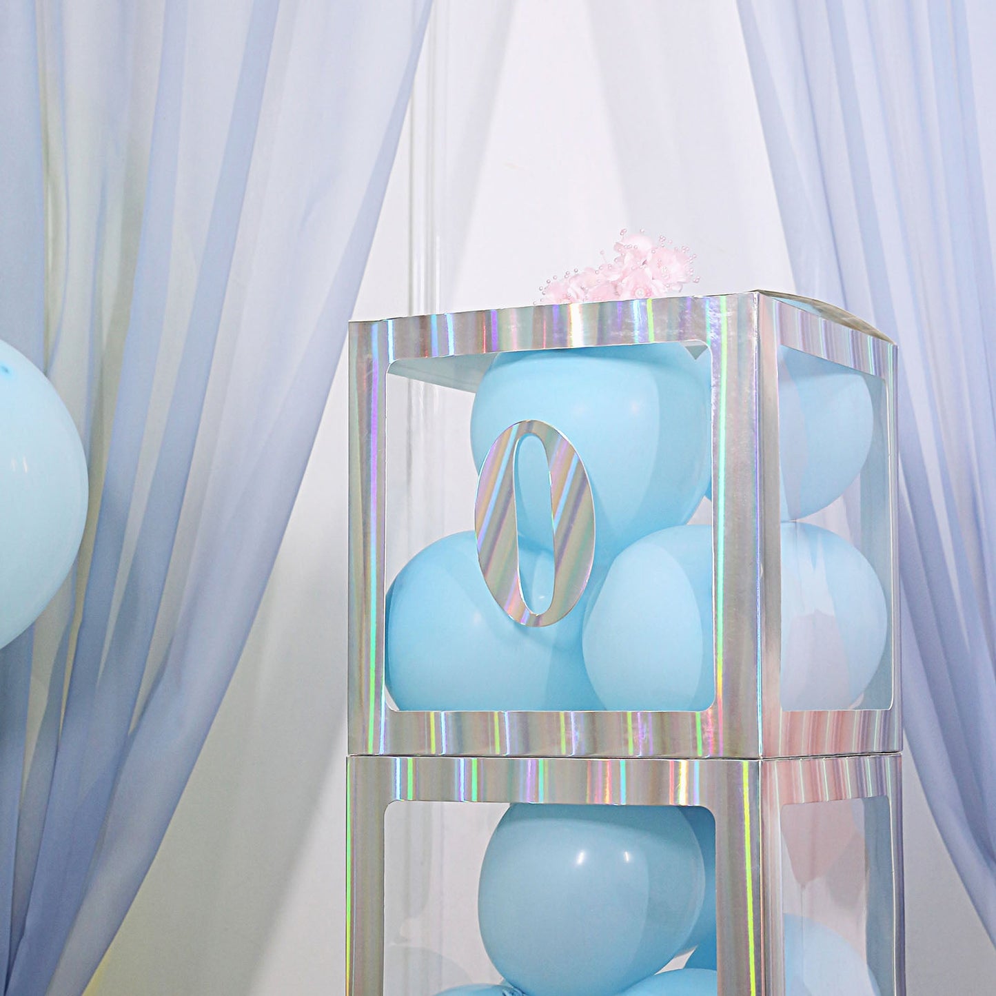 Iridescent 0-9 number stickers on a display with blue balloons.