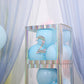 Iridescent number 2 sticker on a display with blue balloons.