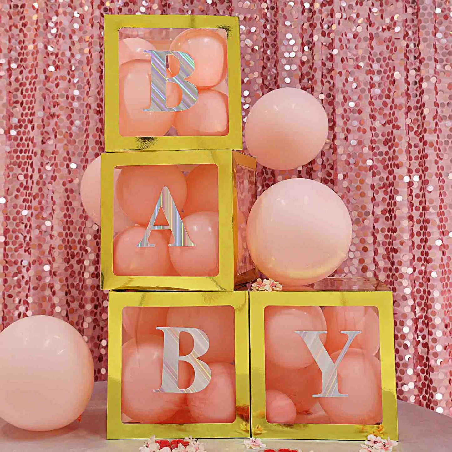 Iridescent alphabet stickers on yellow blocks with pink balloons.