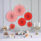Red hanging paper fan decorations in various sizes for a festive backdrop.