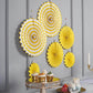 Yellow hanging paper fan decorations set, perfect for party backdrops.