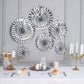 Metallic silver hanging paper fan decorations for party backdrop.