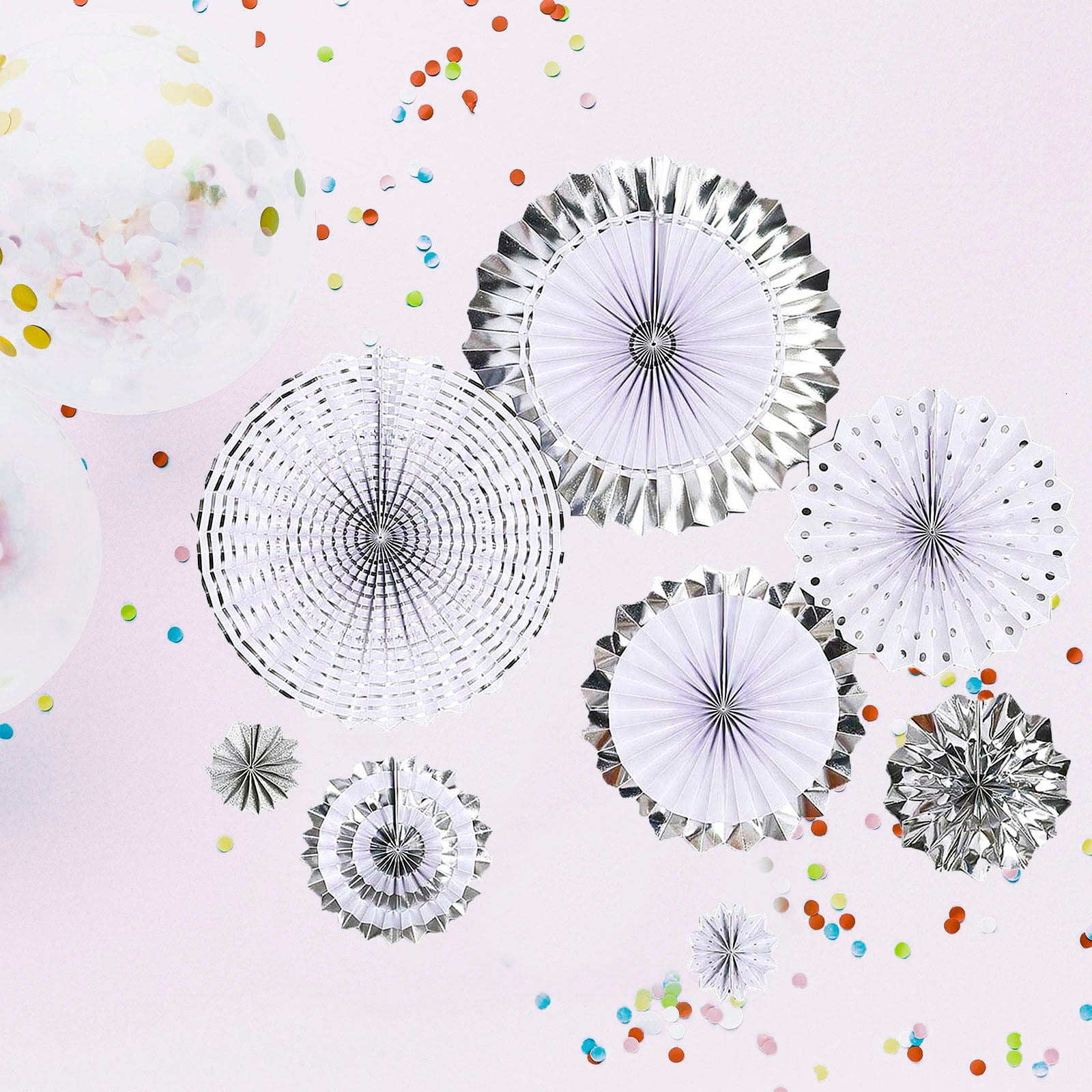 Silver and white hanging paper fan decorations for party backdrop.