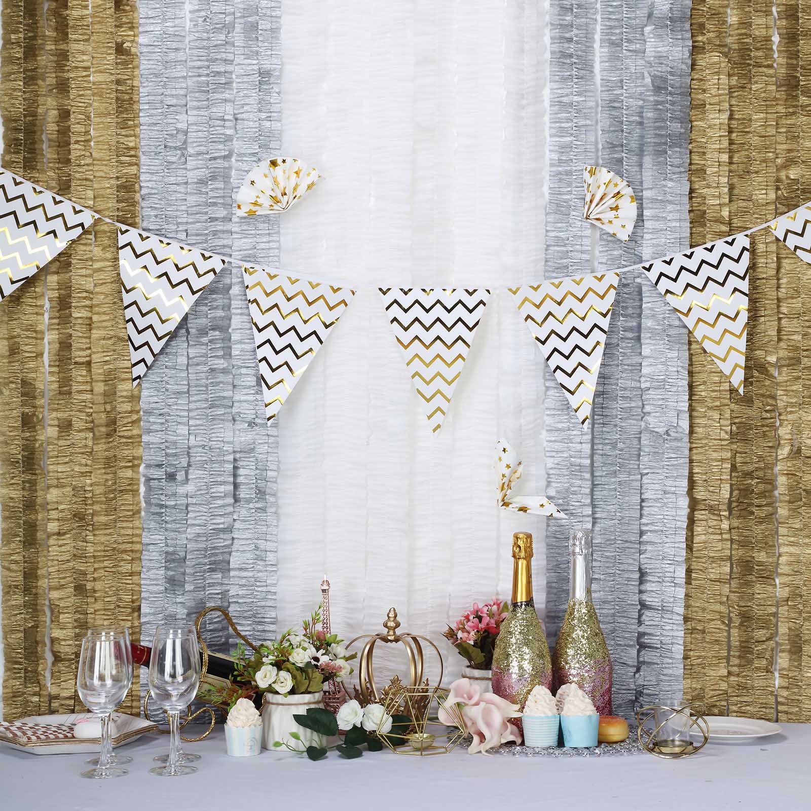 White ruffled paper streamers and party decorations in a festive setting.