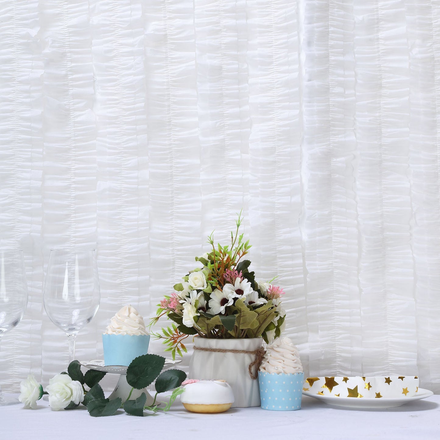 White ruffled paper streamers for party decorations and floral arrangement.