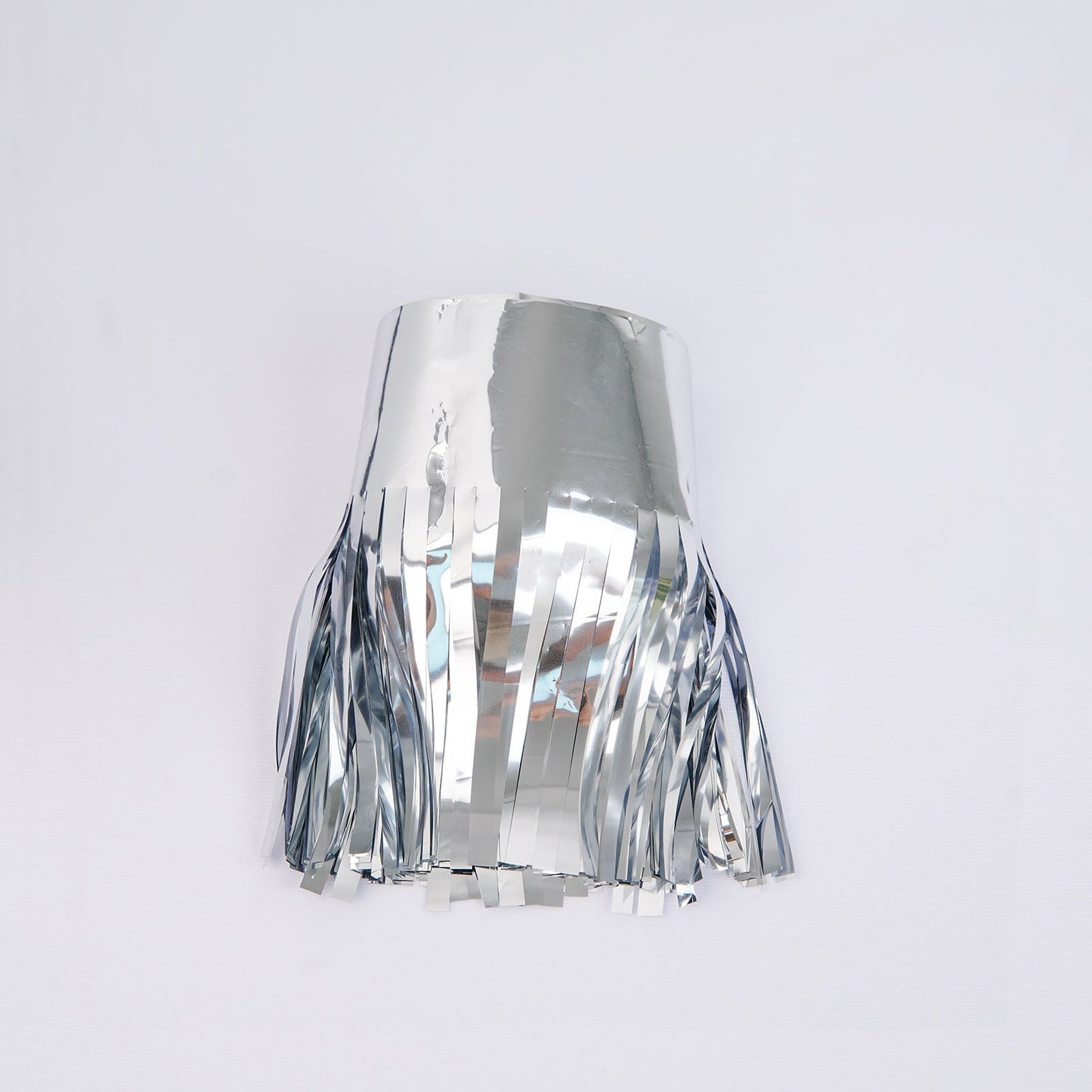 Metallic silver foil tassel fringe backdrop banner for party decor.