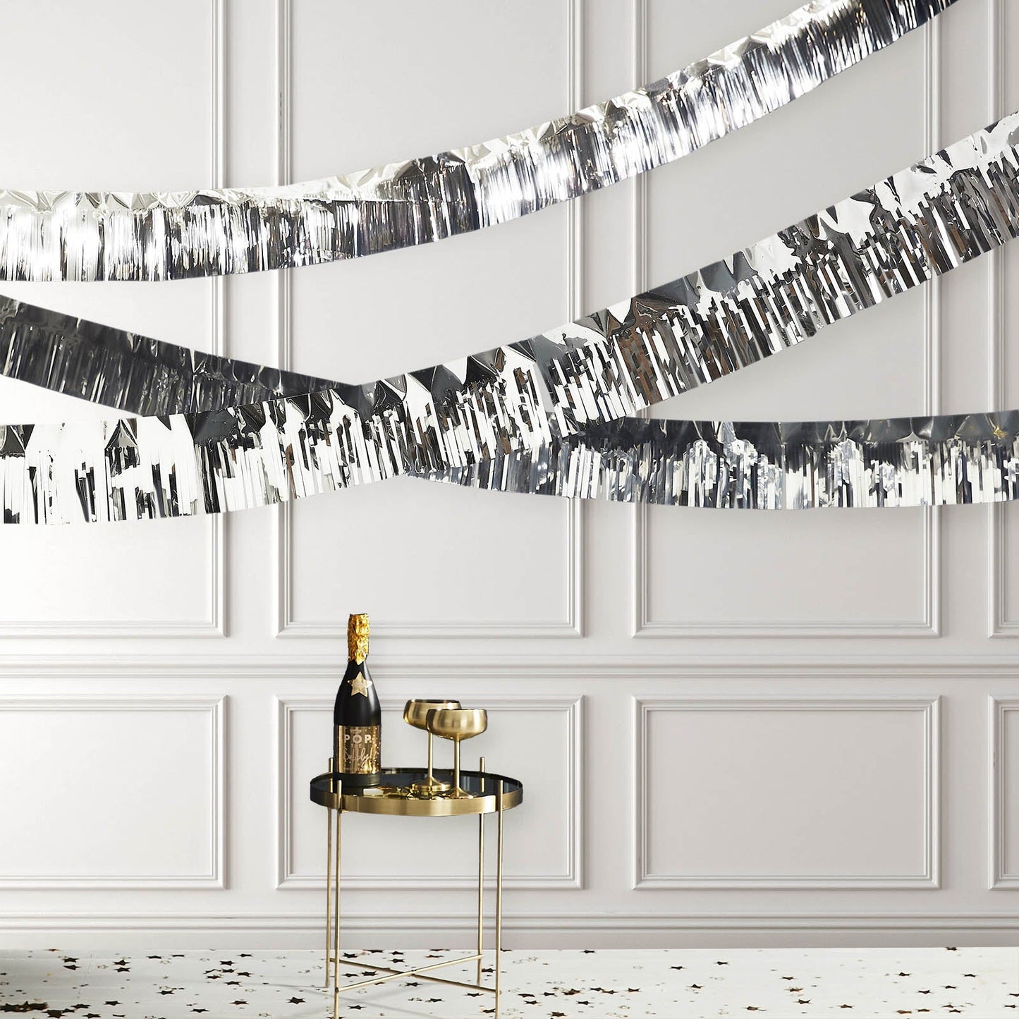 Metallic silver foil tassel fringe backdrop banner decor.