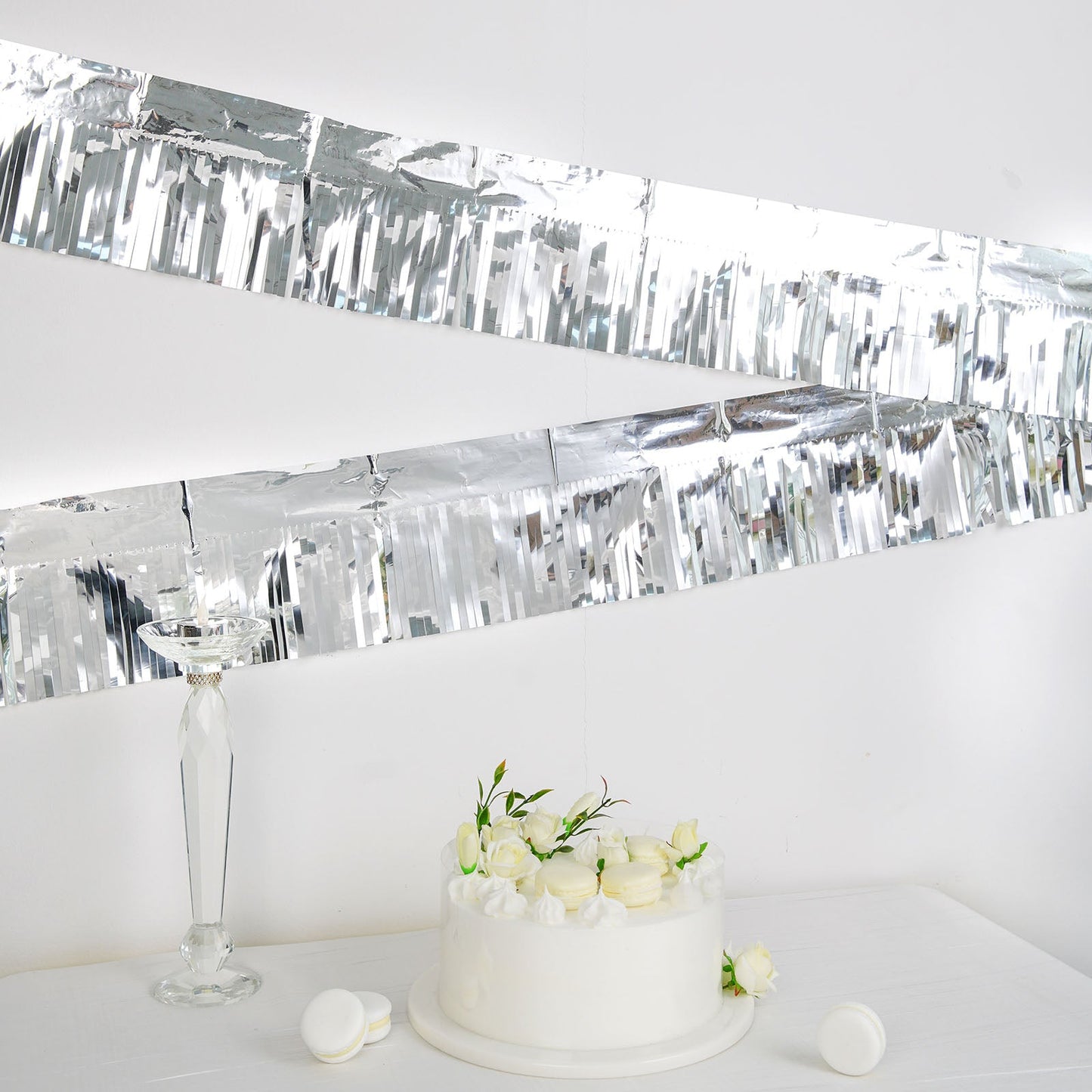 Metallic silver foil tassel fringe backdrop banner decoration.