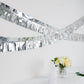 16ft metallic silver foil tassel fringe backdrop banner decor on display.