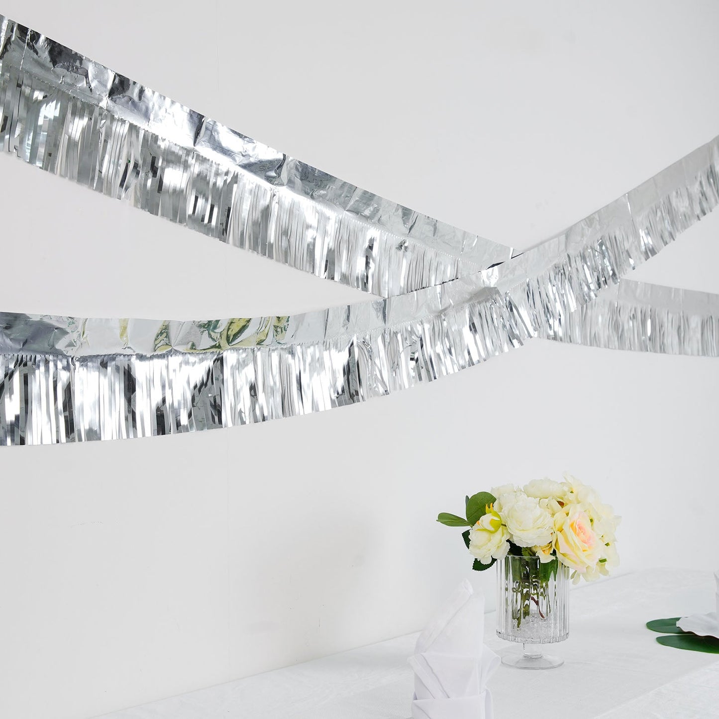 16ft metallic silver foil tassel fringe backdrop banner decor on display.