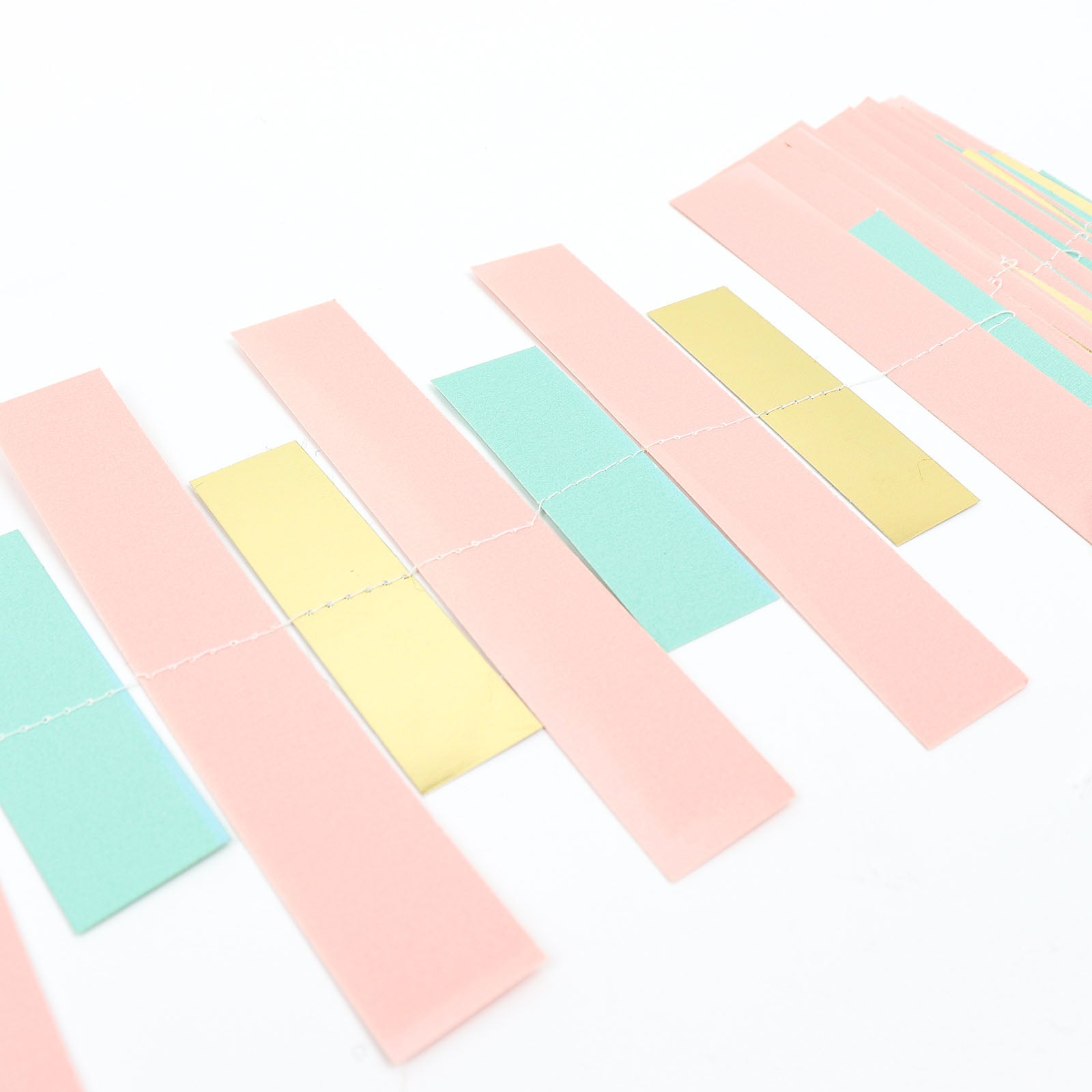 Gold, blush, and turquoise paper garland streamer decoration.