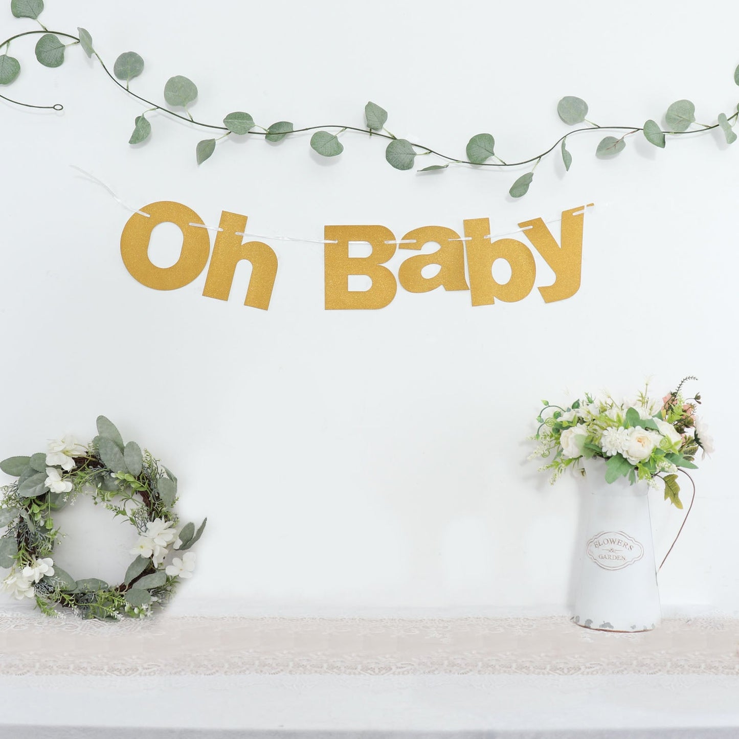 Gold glittered "Oh Baby" garland banner for baby shower decoration.
