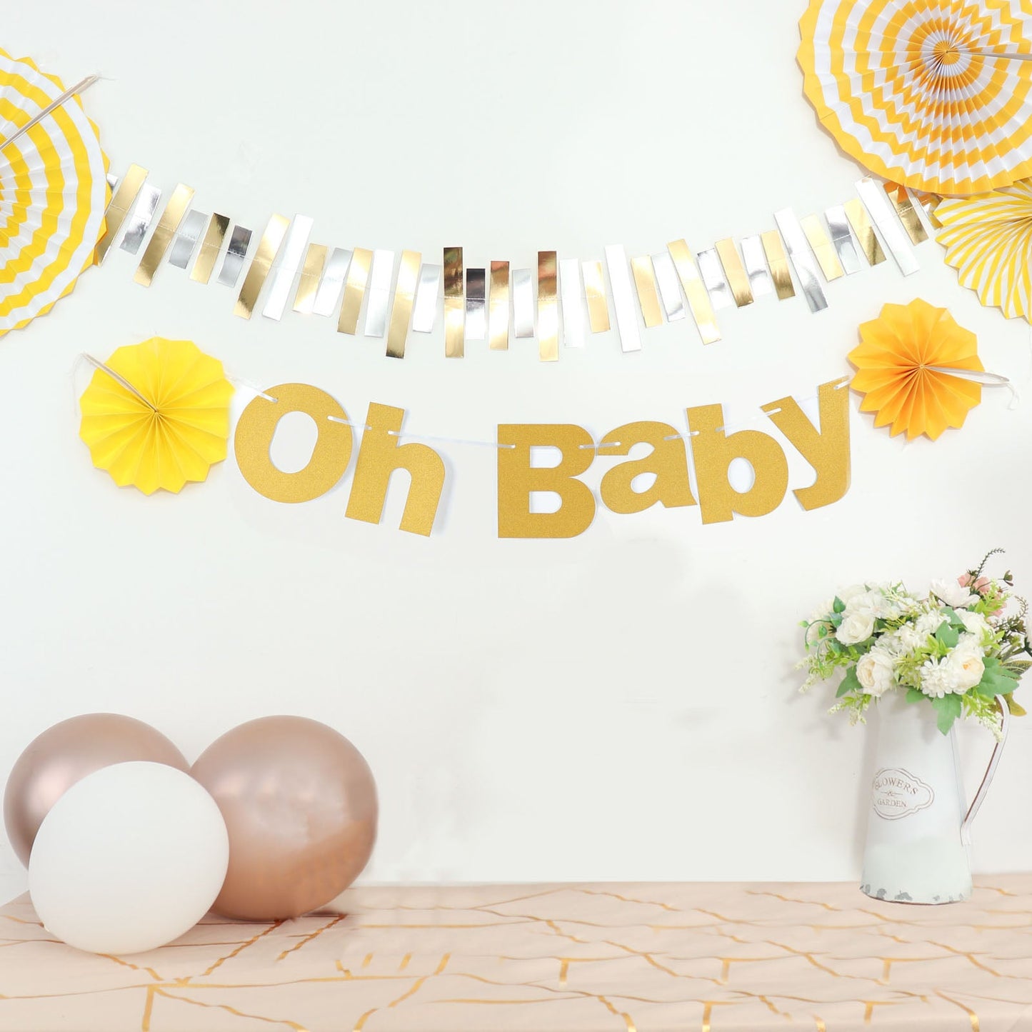Gold glittered "Oh Baby" banner for baby shower decoration.