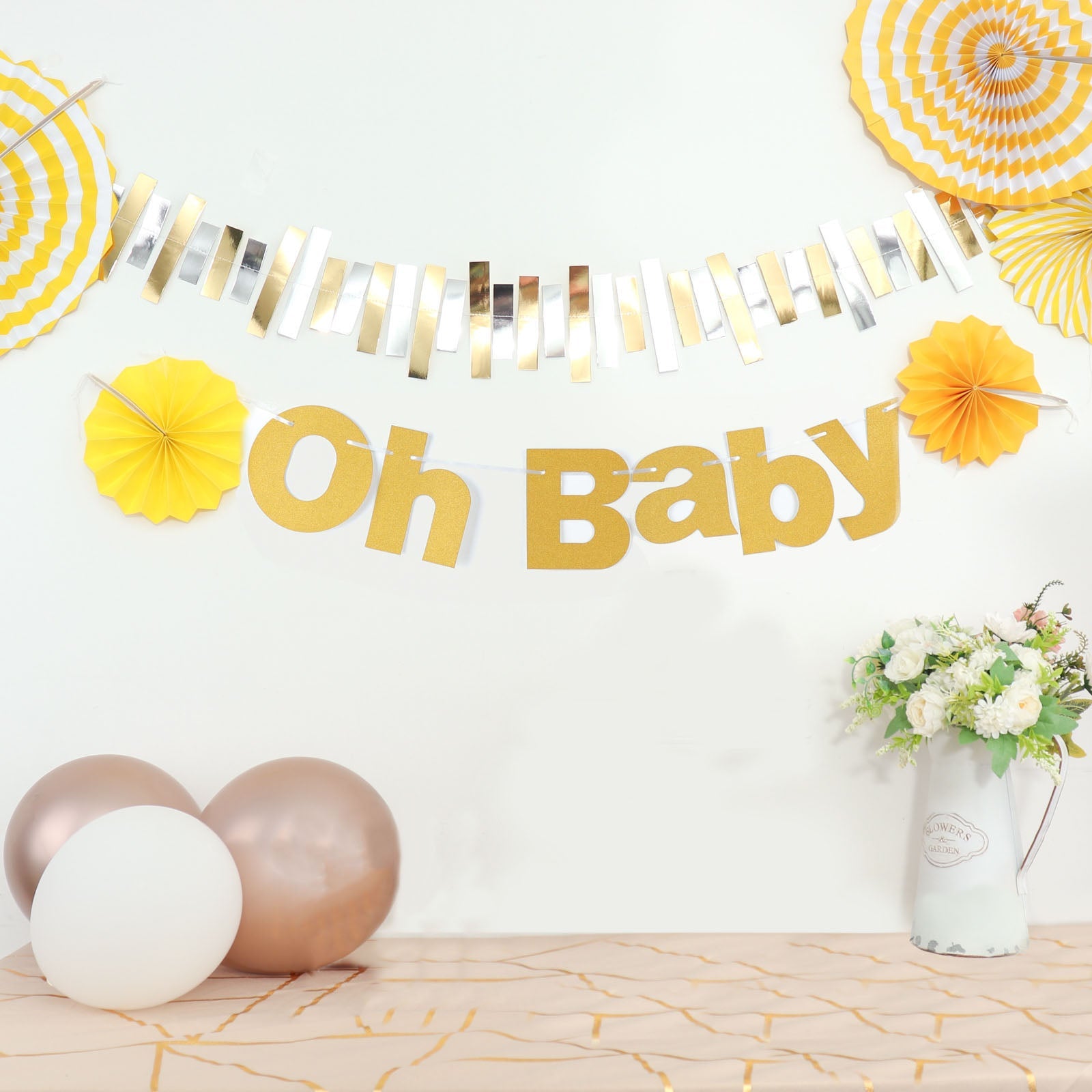 Gold glittered "Oh Baby" banner for baby shower decoration.