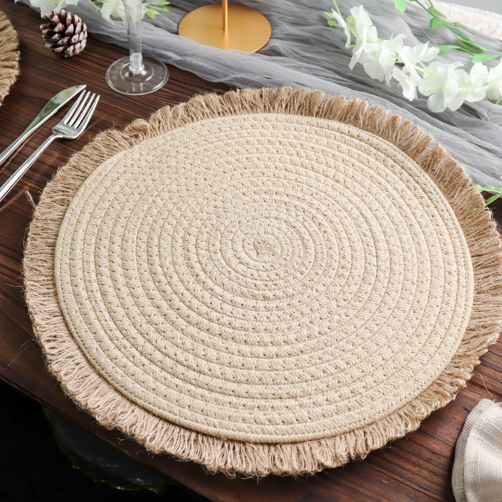 Natural burlap round placemat with fringed edges, perfect for farmhouse decor.
