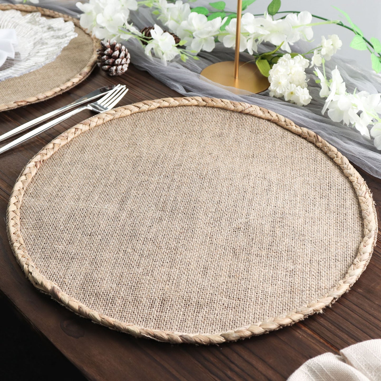 Natural burlap round placemat with braided edges, perfect for farmhouse dining.