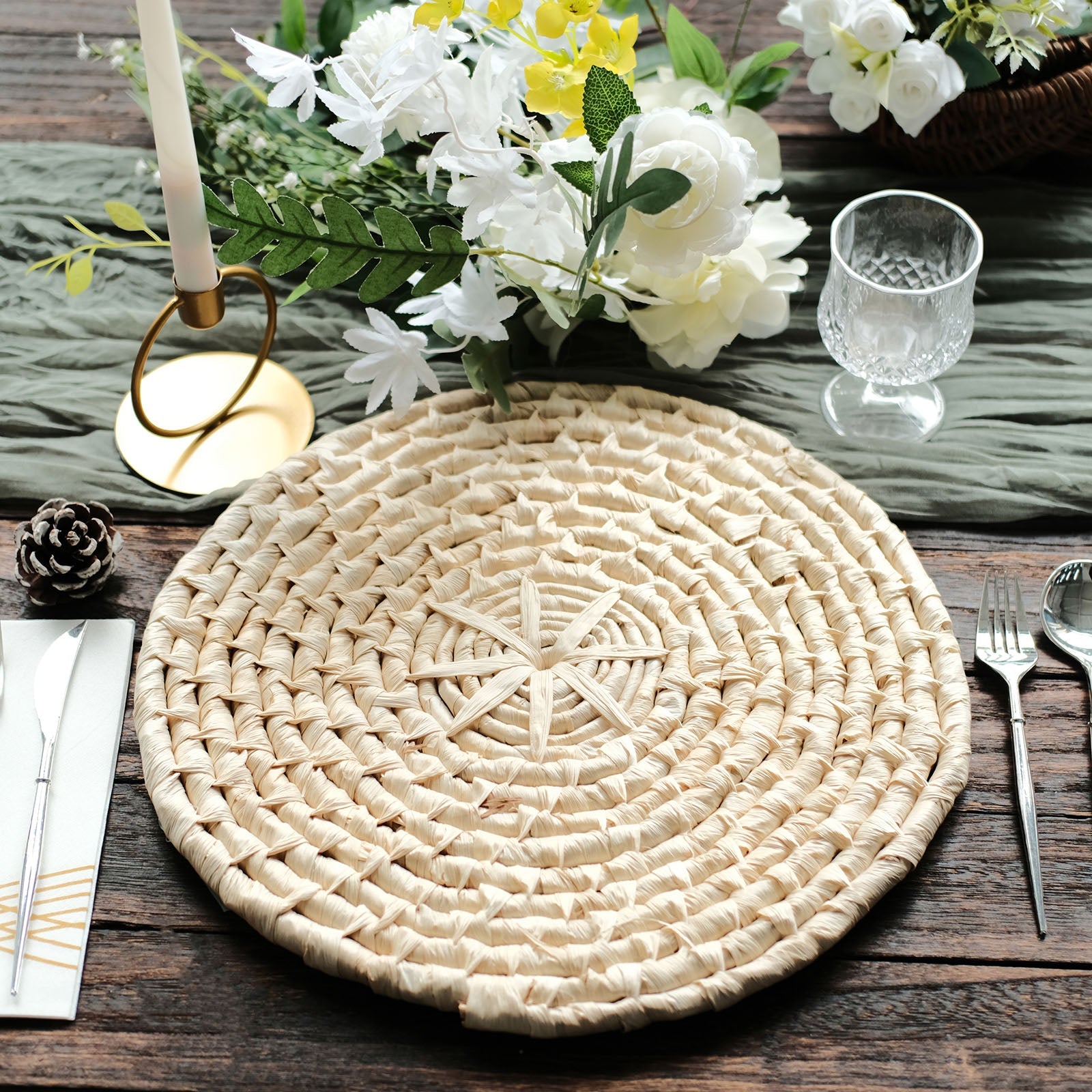 Natural corn husk round woven placemats on a rustic wooden table.