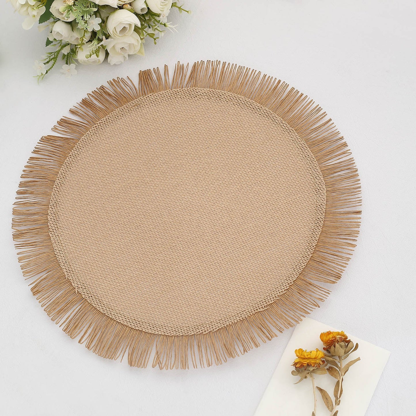 Natural rustic burlap table mat with jute fringe edge.