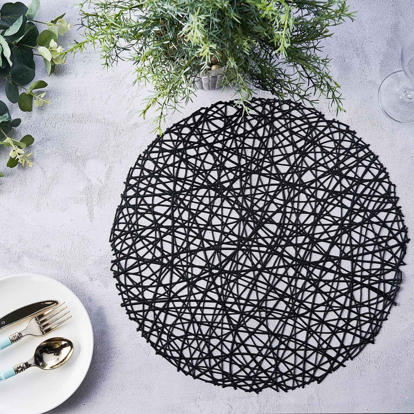 Black vinyl round placemat, decorative woven non-slip design, 15 inches.