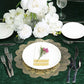 Gold vintage floral lace placemats on a dining table with white flowers.