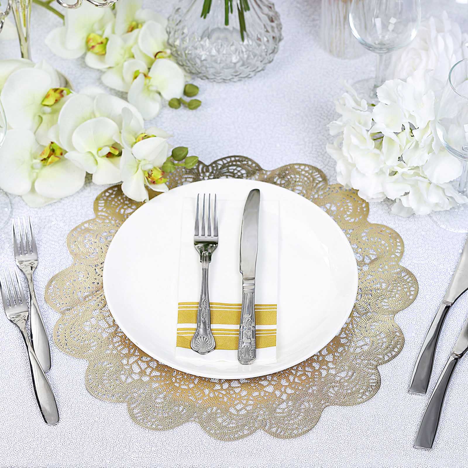 Gold vinyl placemats with vintage floral lace design on a dining table setting.