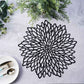 Black vinyl round placemat with decorative floral design.