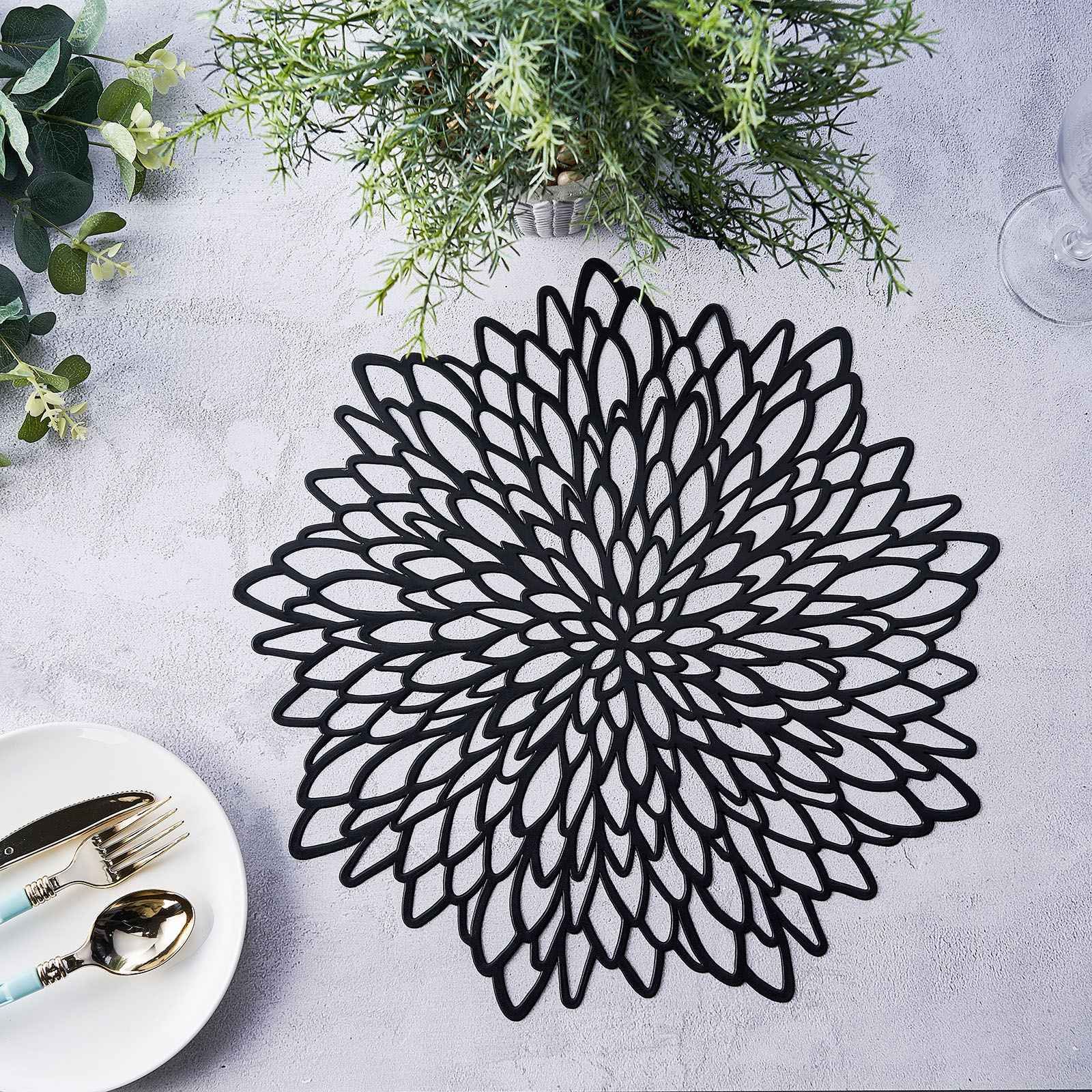 Black vinyl round placemat with decorative floral design.