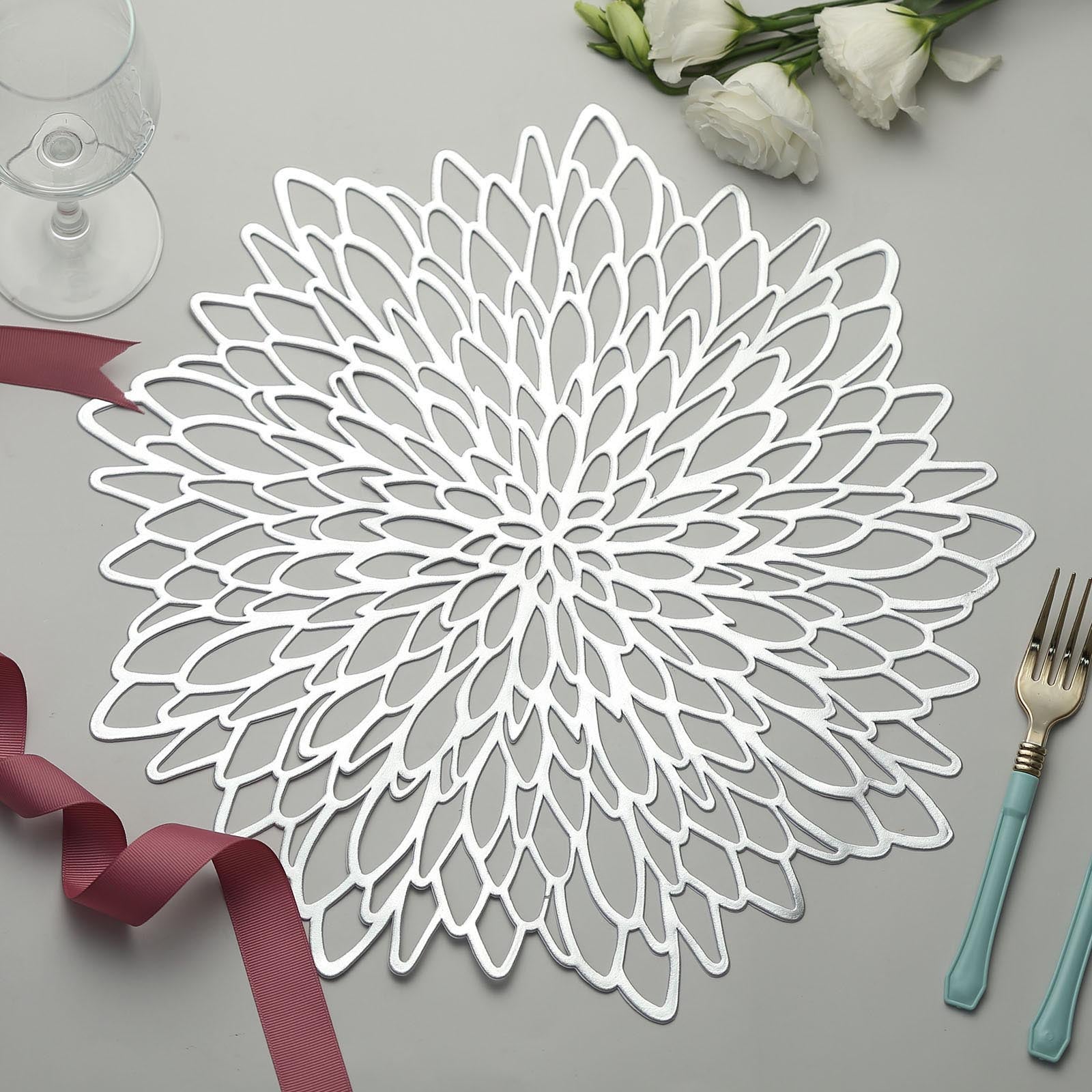 Silver floral vinyl placemat on dining table with decorative elements.