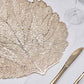 Gold metallic fall leaf vinyl placemat on a dining table setting.