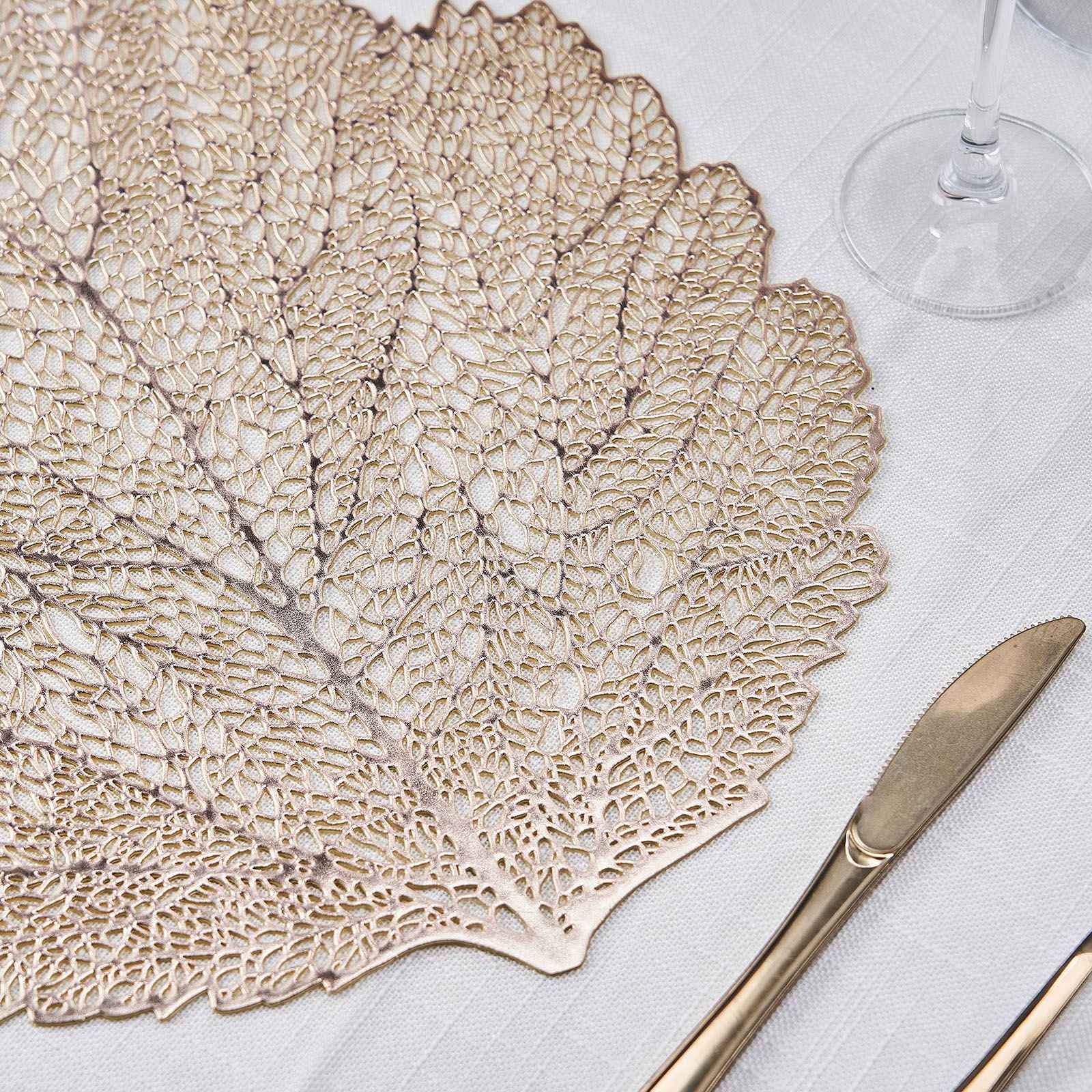 Gold metallic fall leaf vinyl placemat on a dining table setting.