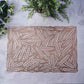 Rose gold vinyl placemat with a metallic wheat design.