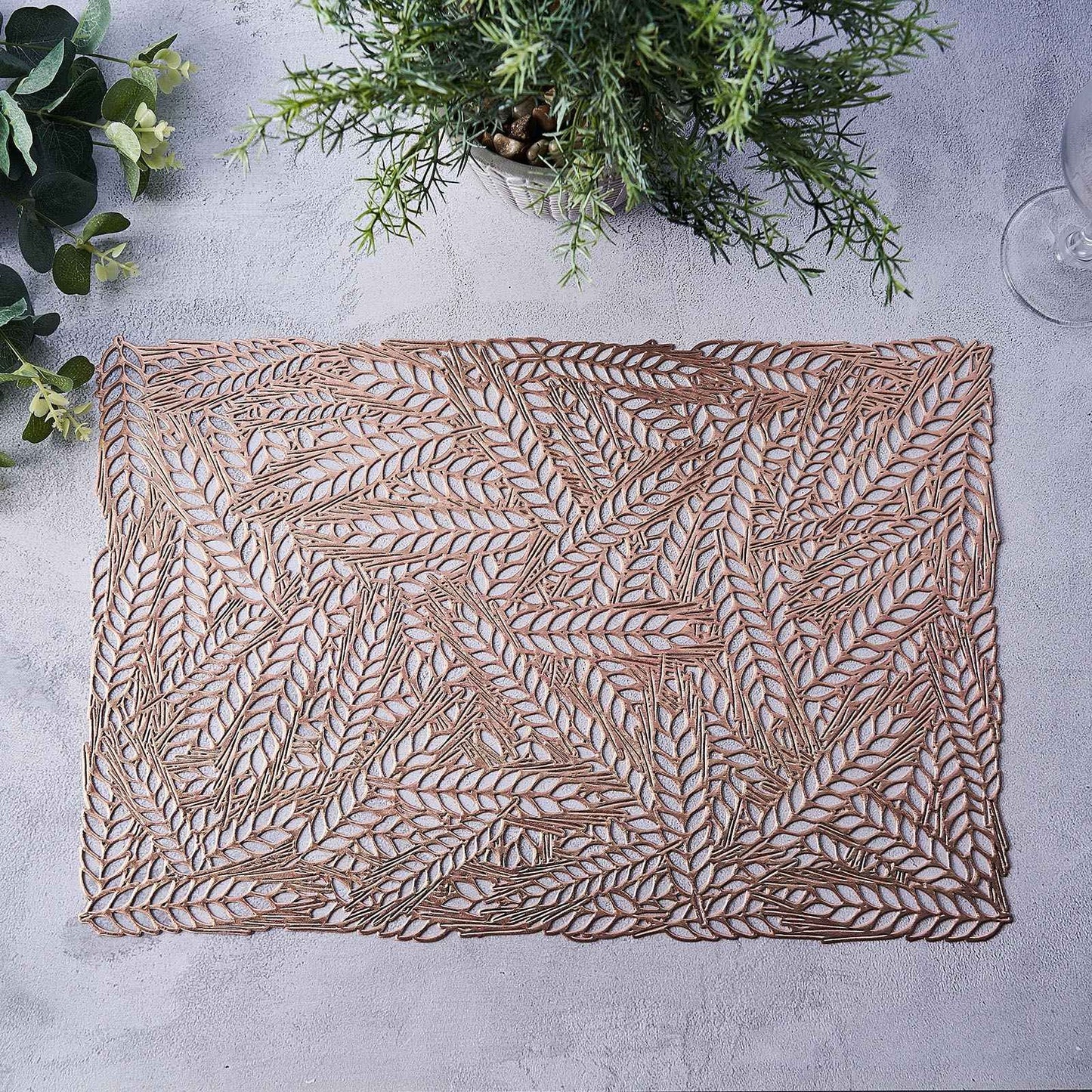 Rose gold vinyl placemat with a metallic wheat design.