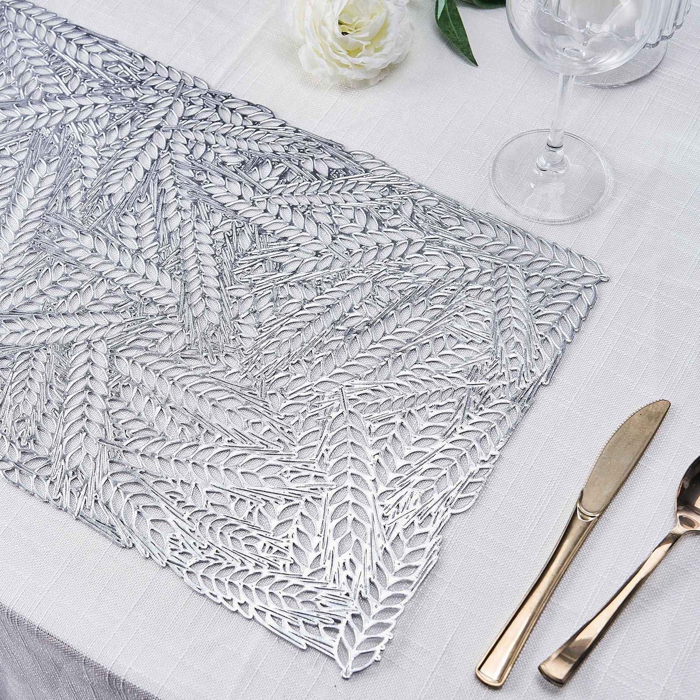 Silver vinyl placemat with a metallic wheat design on a table setting.
