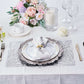 Silver vinyl placemats with a metallic wheat design on a dining table setting.