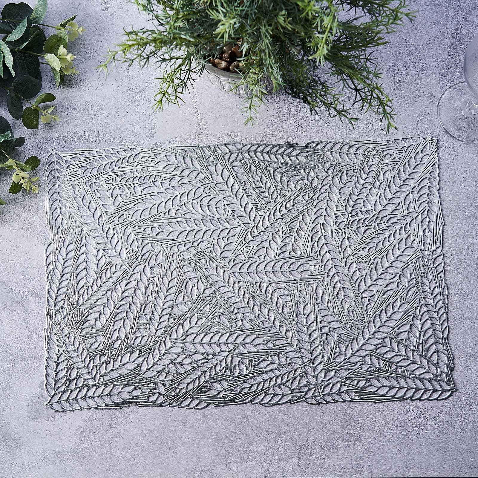 Silver metallic placemat with wheat design on a light surface.