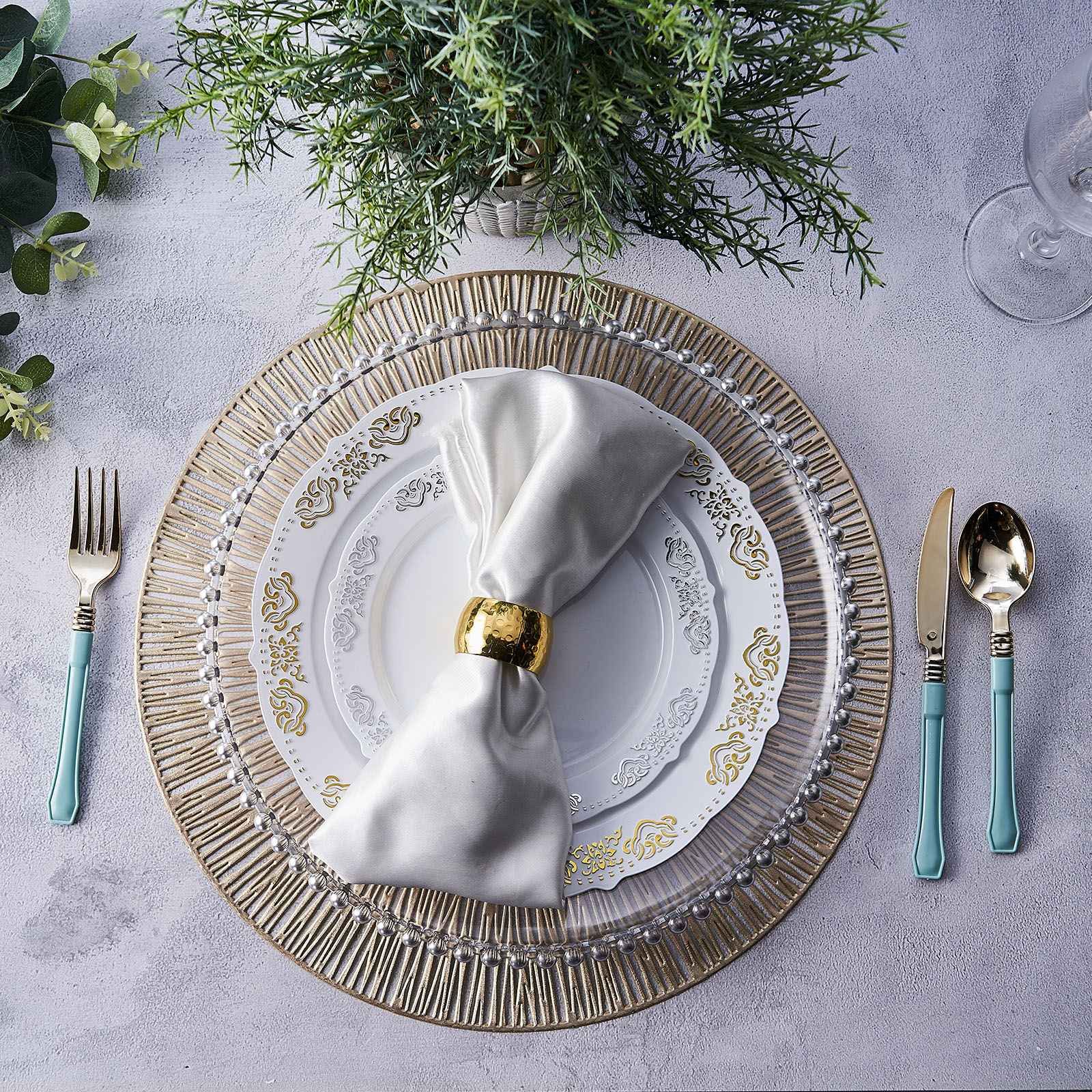 Gold metallic round placemats with a non-slip spiked design on a dining table.
