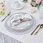 Silver metallic round placemats with a non-slip spiked design.