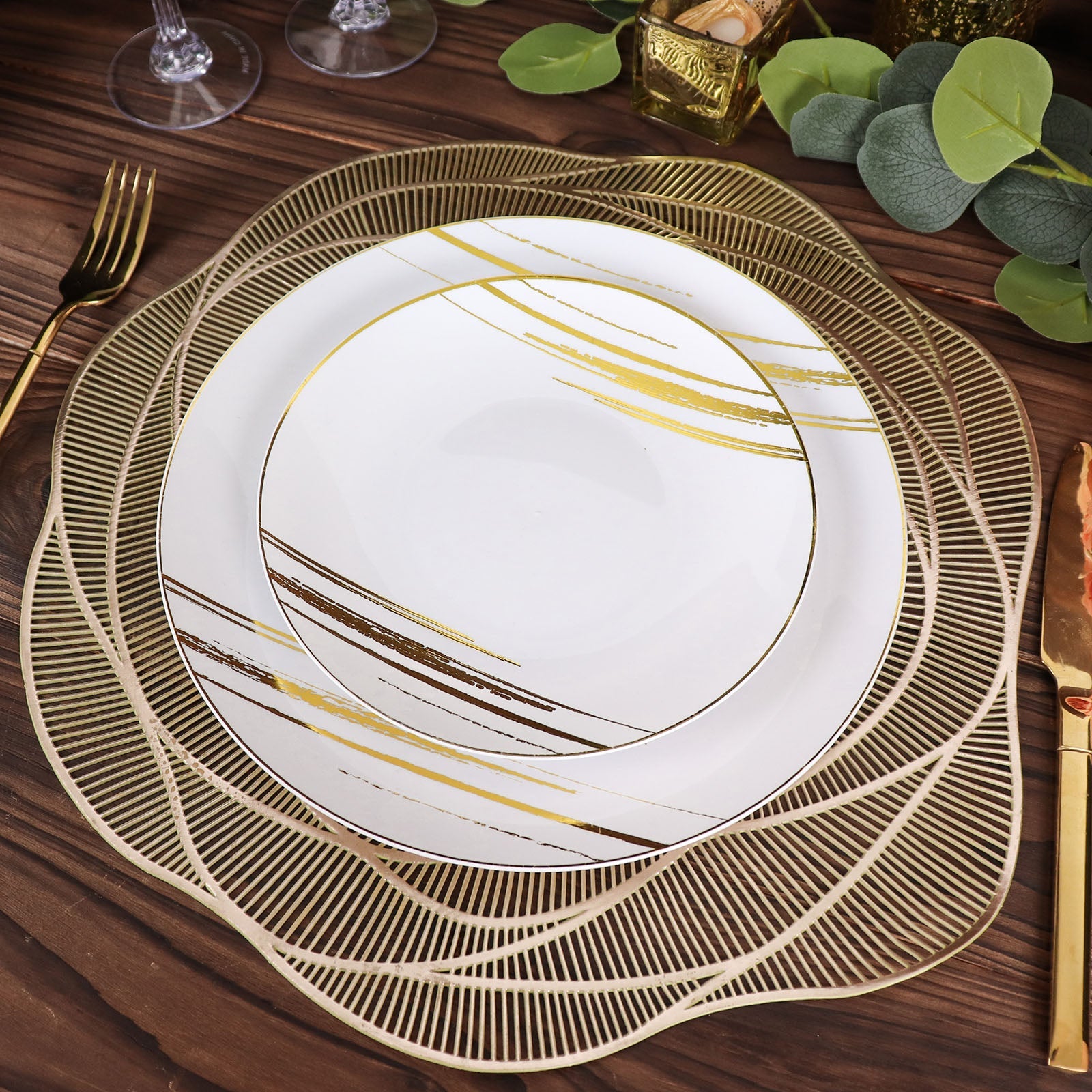Metallic gold round vinyl placemats with rose flower design on a dining table.