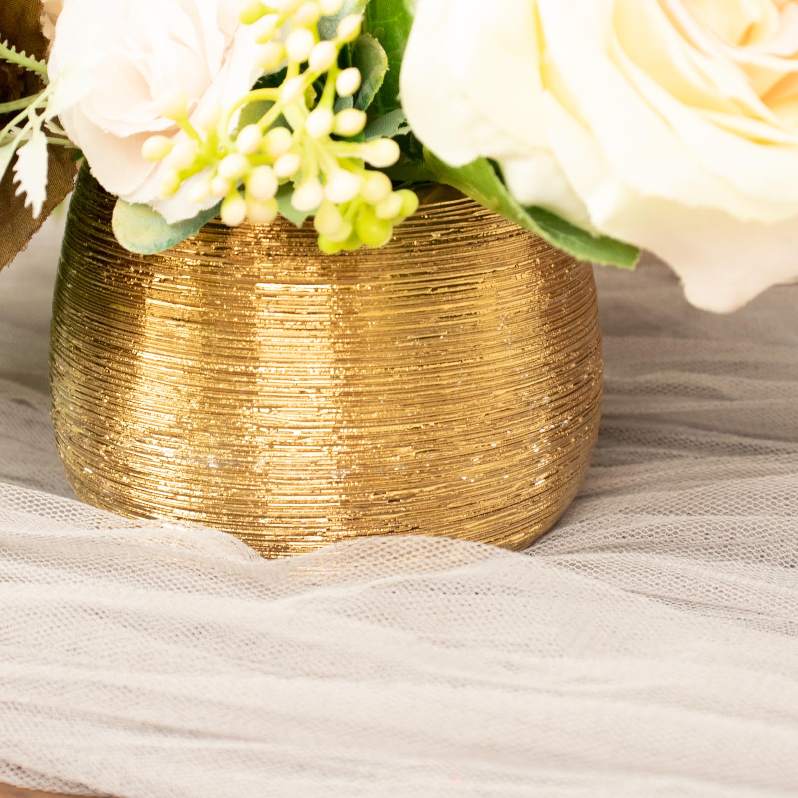 Gold textured ceramic flower vase pot with round brushed design.