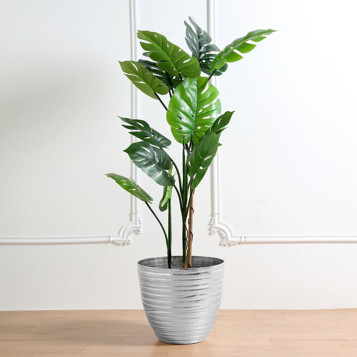 Metallic silver textured large indoor flower plant pot with green leaves.