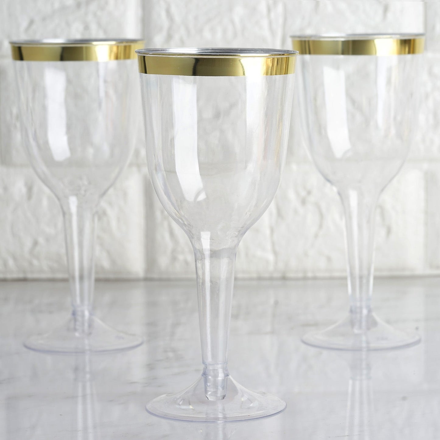 Clear plastic wine goblet glasses with gold rim, set of three.