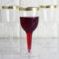 9oz clear plastic wine goblet with gold rim, filled with red beverage.