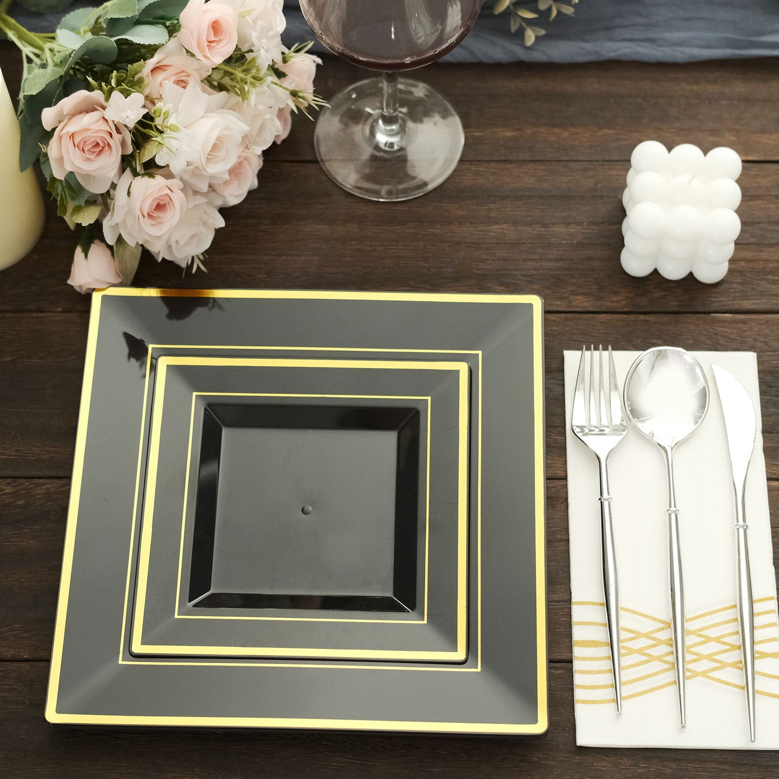 Gold trim black square plastic disposable dinner plate.