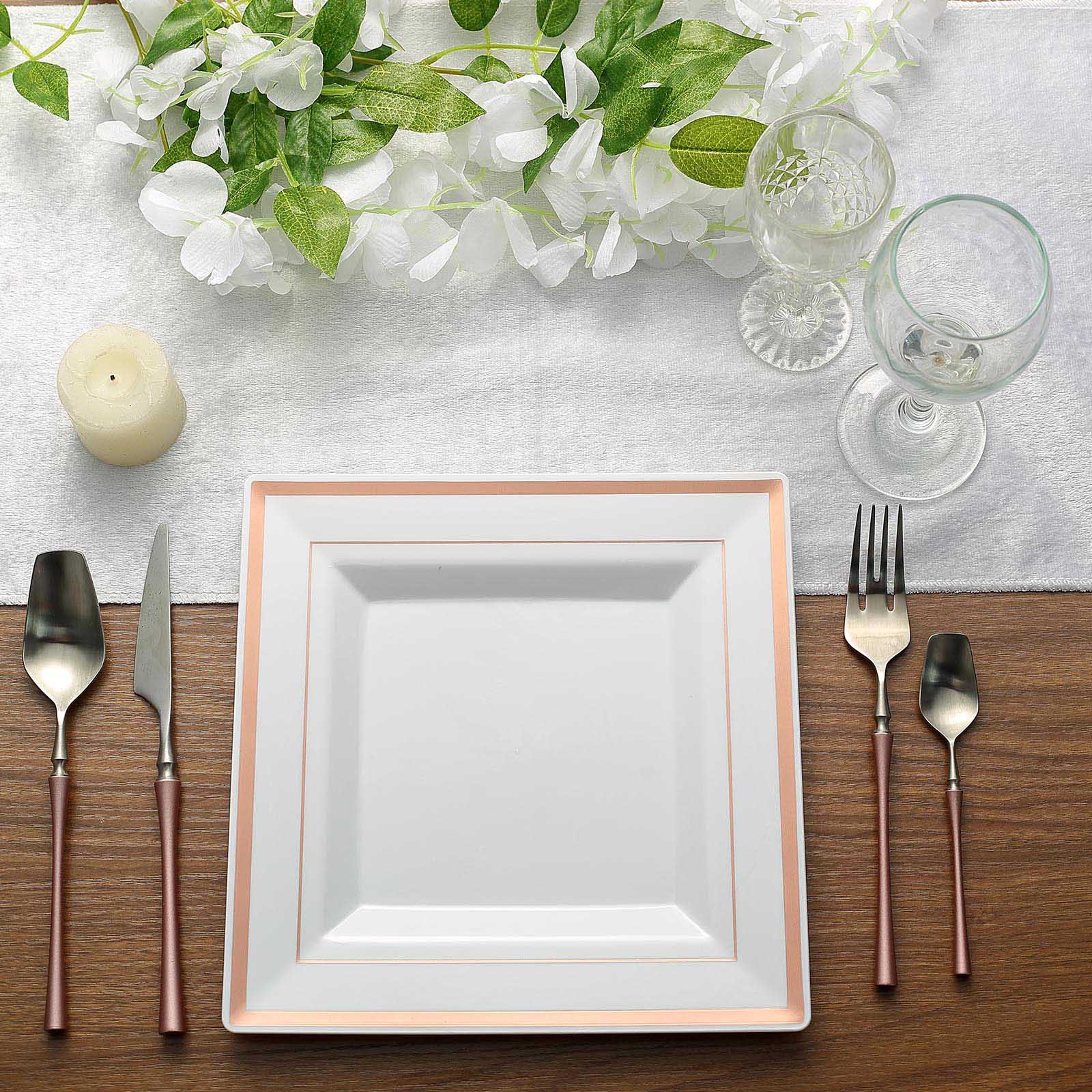 Rose gold trim white square plastic dinner plate on a dining table setting.