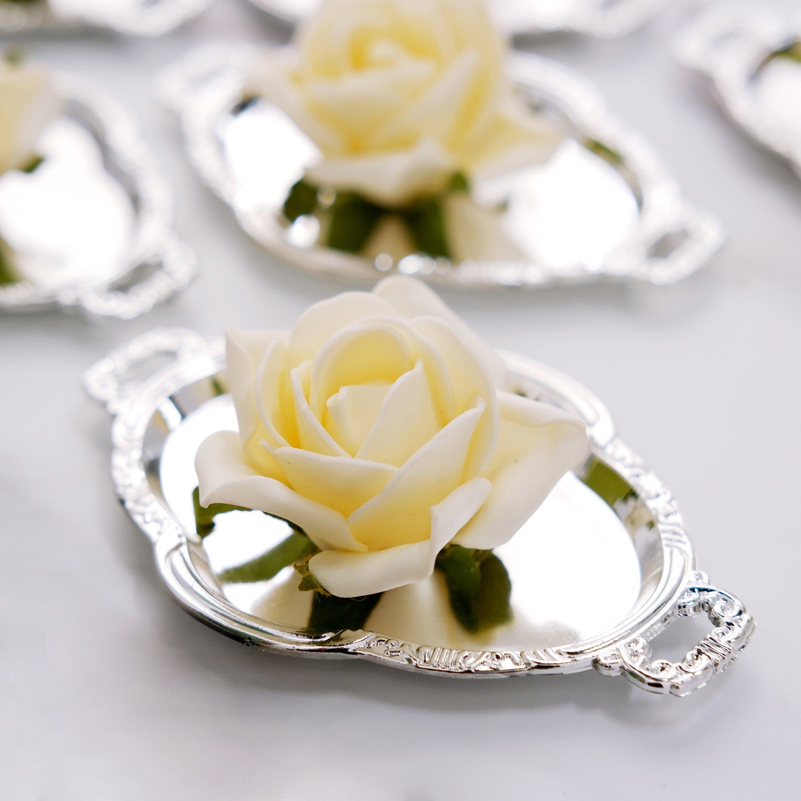 Silver oval mini party favor candy tray with a white rose.