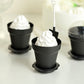 Black small favor jars for desserts and plants with decorative accessories.